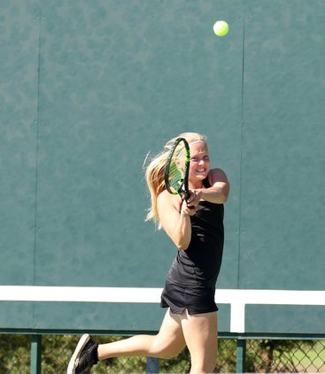 Macy Haas hits a backhand return.jpg